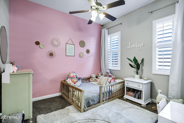 carpeted bedroom with a ceiling fan and baseboards