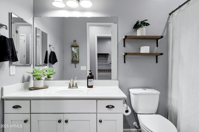bathroom with toilet and vanity