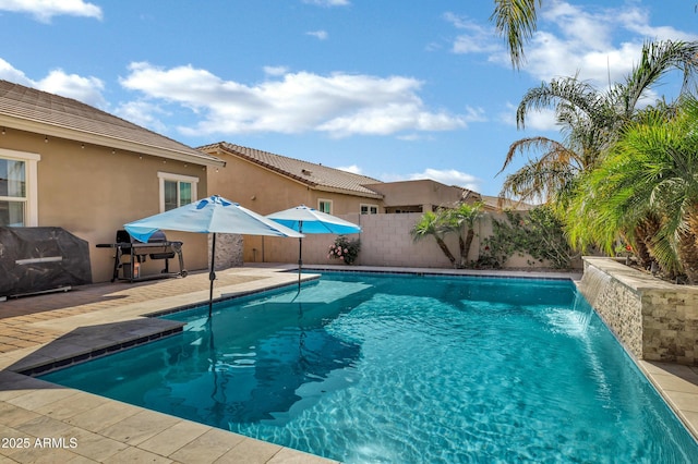 view of pool with a fenced in pool, area for grilling, a patio area, and a fenced backyard