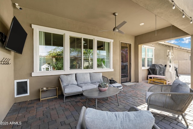 view of patio with grilling area, ceiling fan, and an outdoor living space