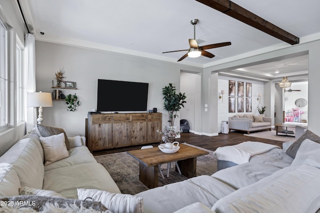 living area with wood finished floors, ceiling fan, and beamed ceiling