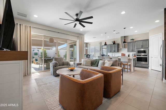 living room with recessed lighting, visible vents, a ceiling fan, and light tile patterned flooring