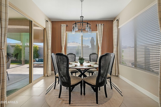 dining room with an inviting chandelier, plenty of natural light, and light tile patterned flooring