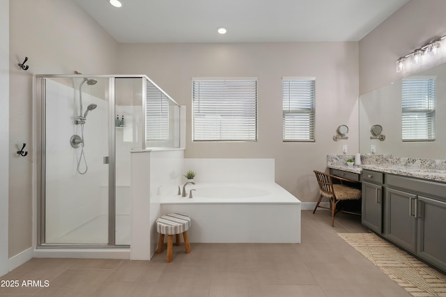 bathroom with a bath, tile patterned flooring, a shower stall, and vanity