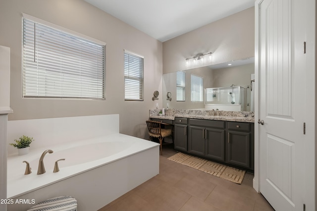 bathroom with tile patterned flooring, a garden tub, a shower stall, and vanity