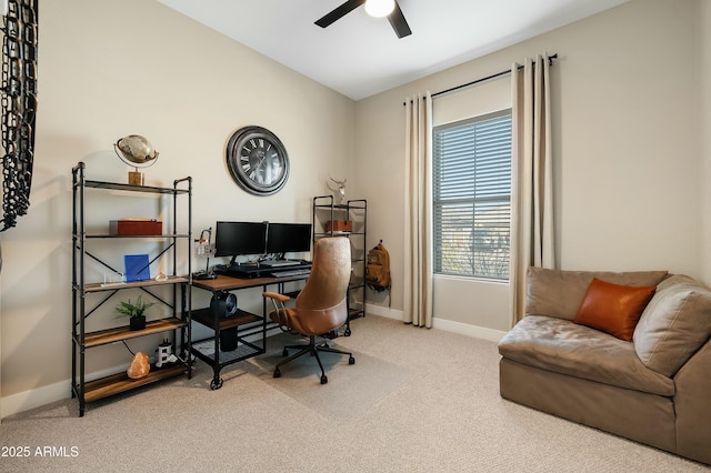 carpeted home office with a ceiling fan and baseboards