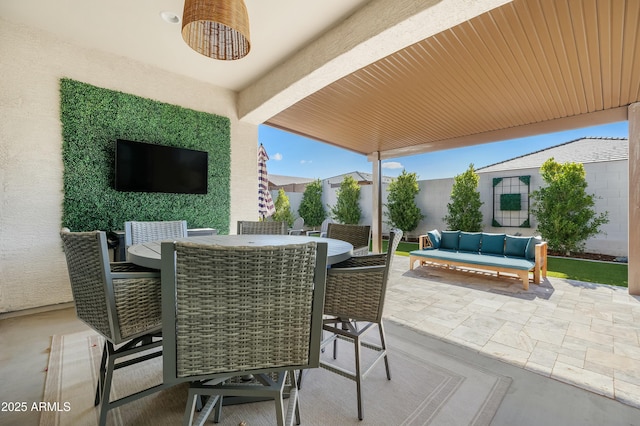 view of patio / terrace featuring fence, outdoor lounge area, and outdoor dining space