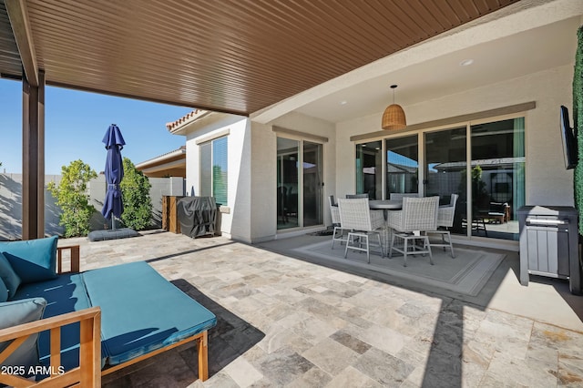 view of patio / terrace with an outdoor hangout area, outdoor dining space, and fence