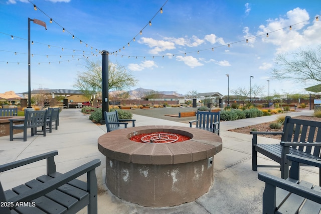 surrounding community featuring a patio area and a fire pit