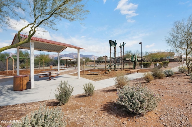 view of community with playground community and a mountain view