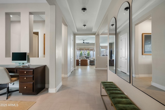 hallway with baseboards and light tile patterned floors