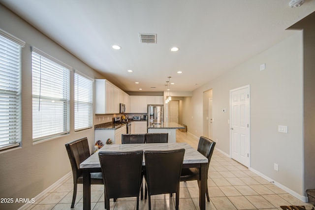 dining area featuring light tile patterned floors, baseboards, recessed lighting, and visible vents