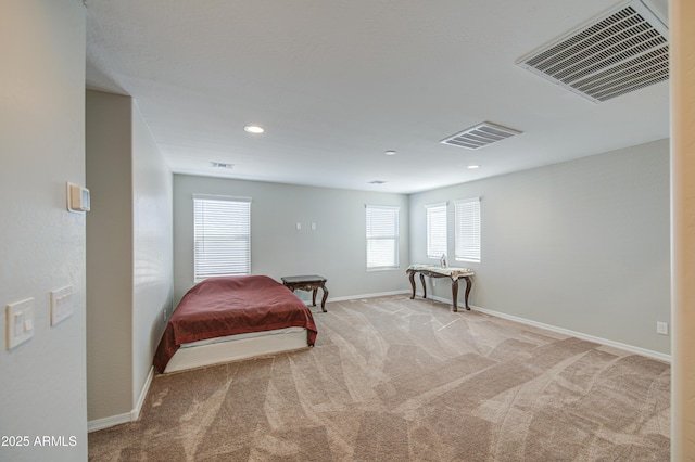 carpeted bedroom featuring visible vents, baseboards, and multiple windows