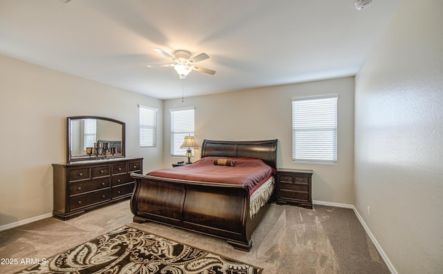 bedroom featuring light carpet, baseboards, and ceiling fan