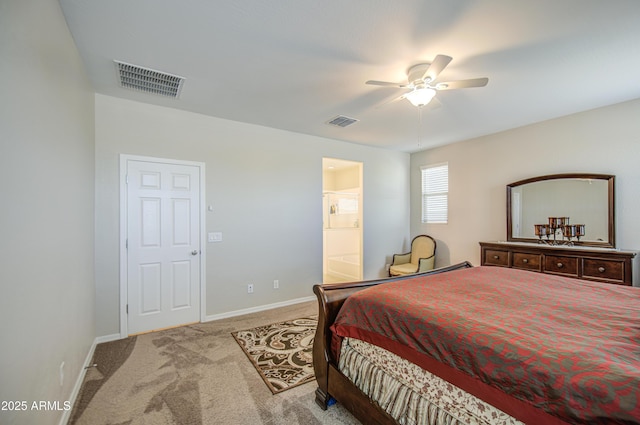 carpeted bedroom with ensuite bathroom, baseboards, a ceiling fan, and visible vents