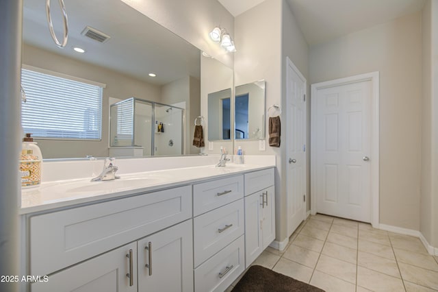 full bathroom with a shower stall, visible vents, a sink, tile patterned floors, and double vanity