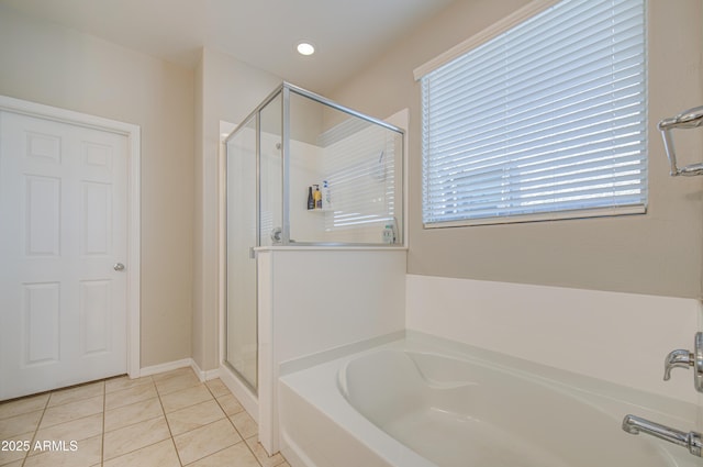 bathroom featuring a wealth of natural light, tile patterned floors, a garden tub, and a stall shower