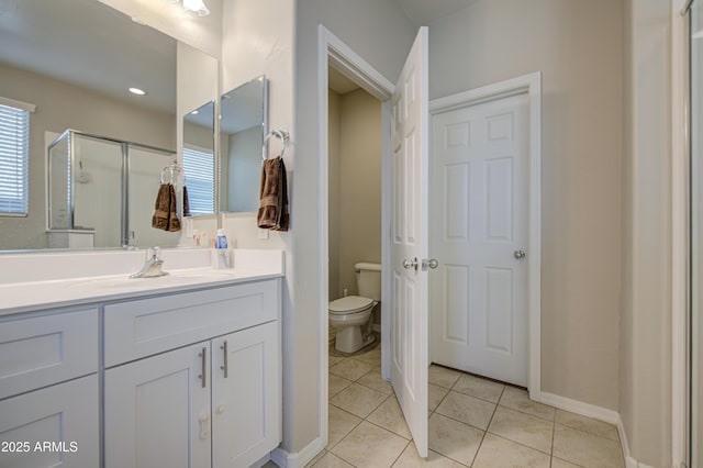 full bath with vanity, baseboards, tile patterned floors, toilet, and a shower stall