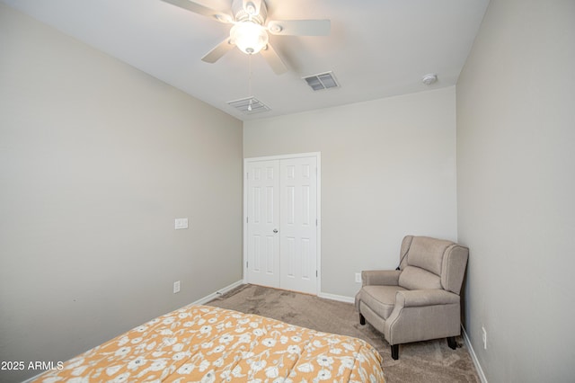 carpeted bedroom featuring visible vents, a closet, baseboards, and a ceiling fan