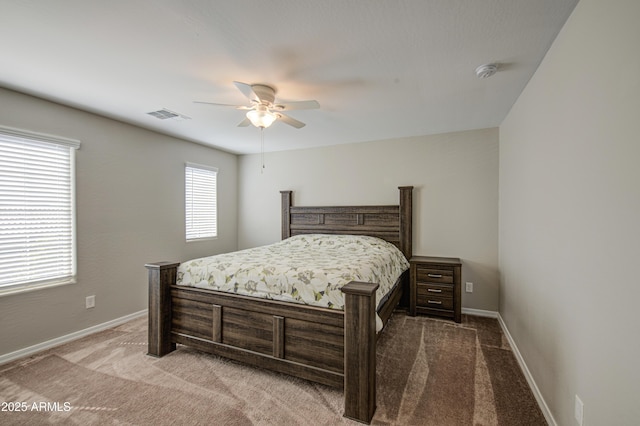 carpeted bedroom featuring visible vents, baseboards, and ceiling fan