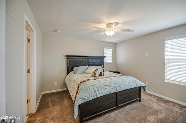 carpeted bedroom with visible vents, baseboards, and a ceiling fan