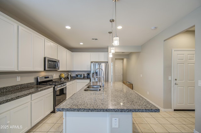 kitchen with light tile patterned floors, white cabinetry, visible vents, appliances with stainless steel finishes, and a sink