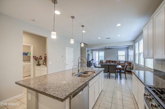 kitchen featuring appliances with stainless steel finishes, recessed lighting, light tile patterned floors, ceiling fan, and a sink