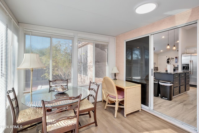 sunroom with plenty of natural light and lofted ceiling