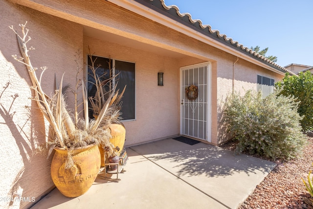 entrance to property with a patio