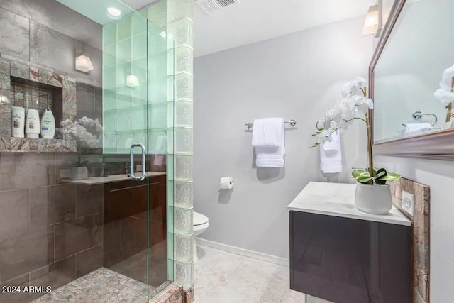 bathroom with vanity, a shower with shower door, and toilet