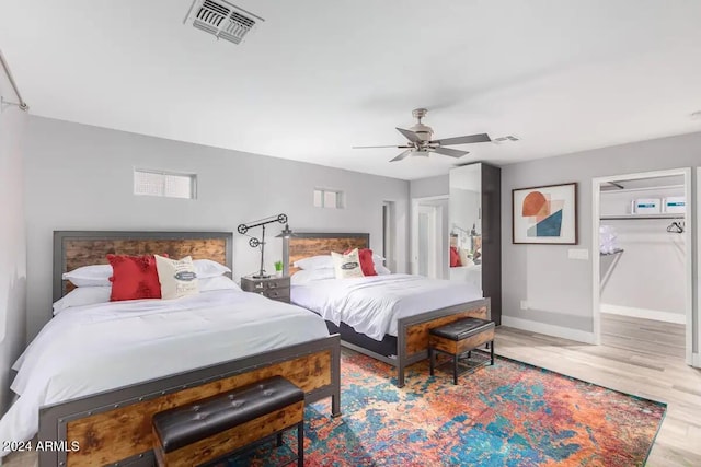 bedroom with light wood-type flooring and ceiling fan