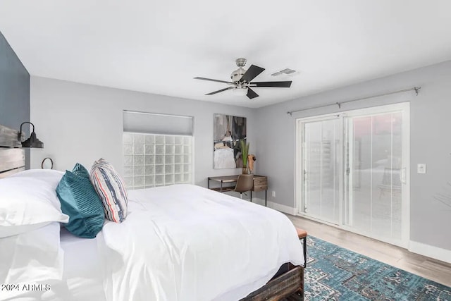 bedroom with access to exterior, wood-type flooring, and ceiling fan