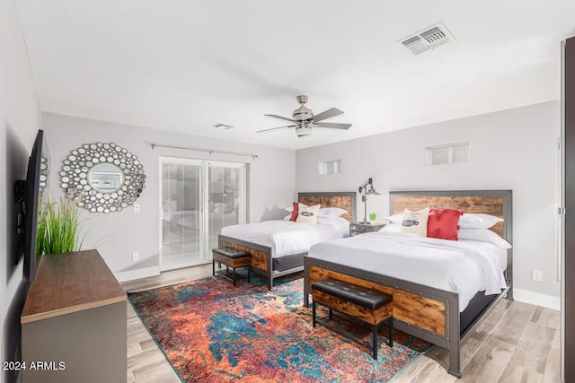 bedroom with light hardwood / wood-style floors and ceiling fan