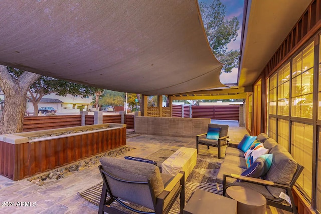 patio terrace at dusk featuring outdoor lounge area