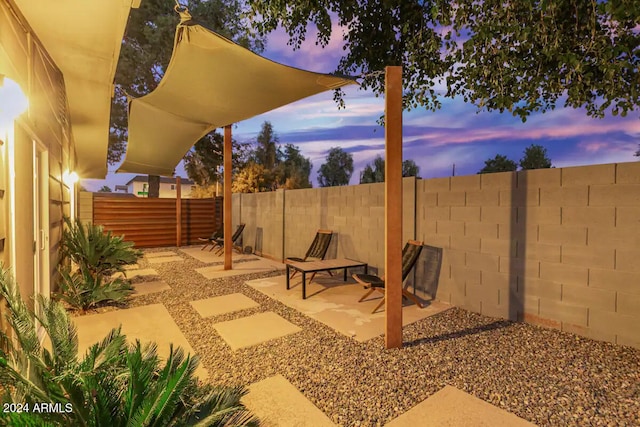 view of patio terrace at dusk