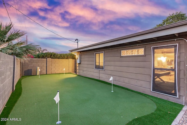 view of yard at dusk