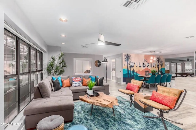 living room featuring ceiling fan and light wood-type flooring