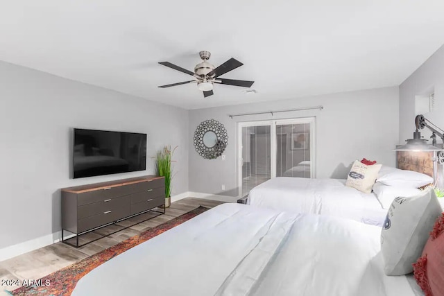 bedroom with access to outside, hardwood / wood-style floors, and ceiling fan