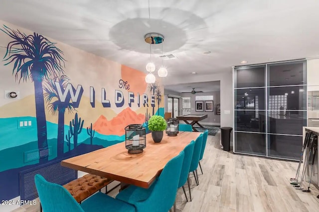 dining area with light hardwood / wood-style floors and ceiling fan