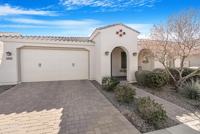 mediterranean / spanish home featuring a garage