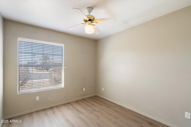 unfurnished room with baseboards, light wood-style flooring, and a ceiling fan