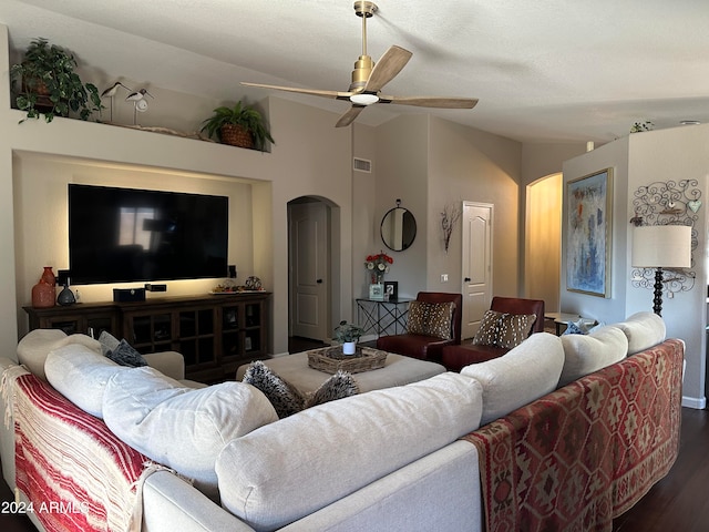 living room featuring ceiling fan, a textured ceiling, lofted ceiling, and dark wood-type flooring