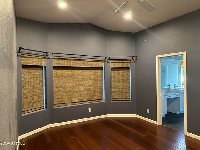 spare room featuring ceiling fan, vaulted ceiling, and dark wood-type flooring