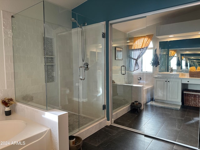 bathroom featuring tile patterned floors, vanity, and separate shower and tub