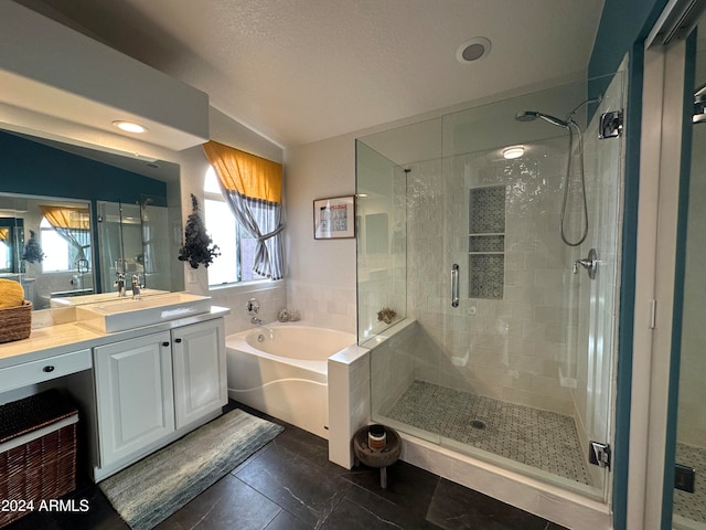 bathroom featuring shower with separate bathtub, lofted ceiling, a healthy amount of sunlight, and vanity