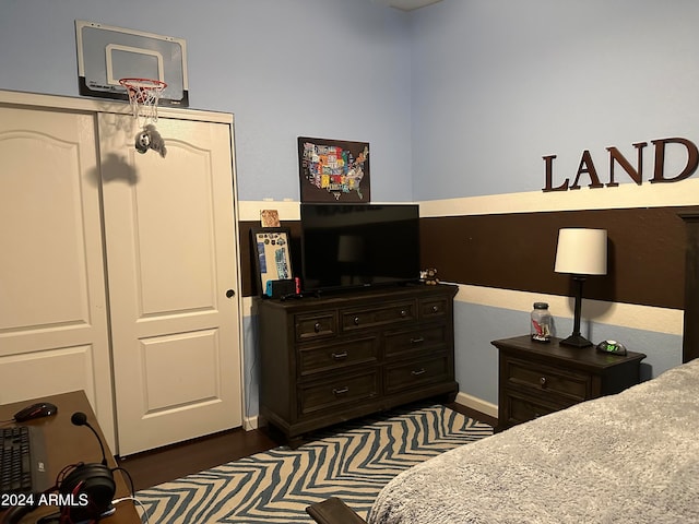 bedroom featuring a closet and dark wood-type flooring