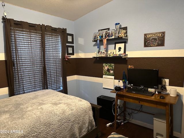 bedroom with dark hardwood / wood-style flooring