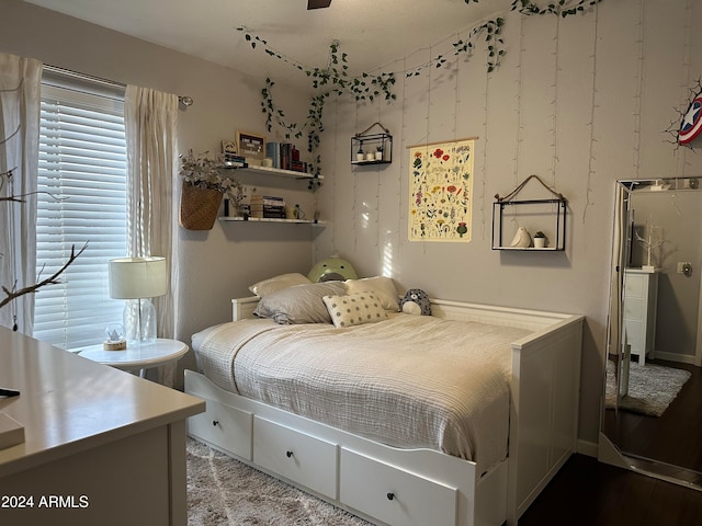 bedroom with hardwood / wood-style flooring and multiple windows