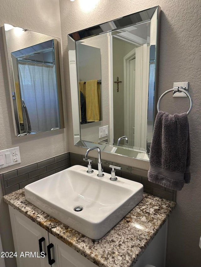 bathroom with vanity and backsplash