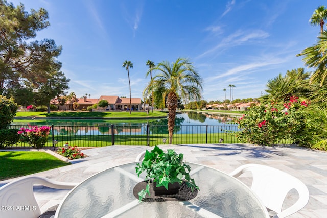 view of community with a water view and a yard